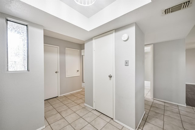 hallway with light tile patterned floors