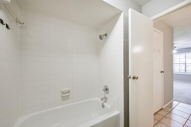 bathroom featuring tile patterned floors, tiled shower / bath, and ceiling fan