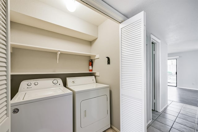 laundry area with tile patterned floors and washing machine and clothes dryer