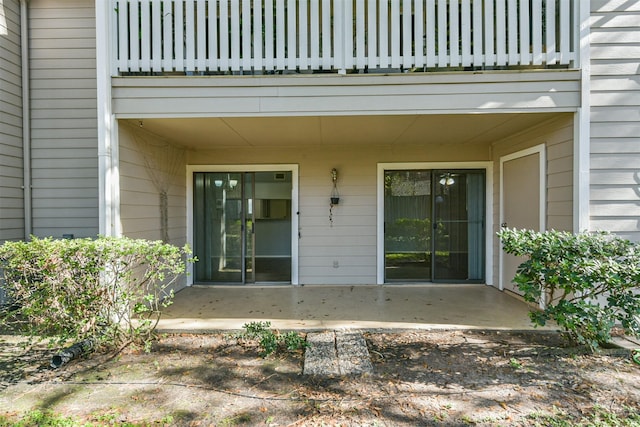 property entrance featuring a balcony and a patio area