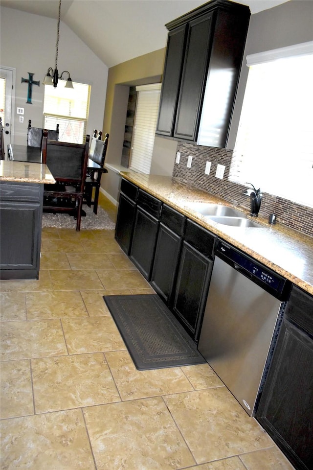 kitchen with stainless steel dishwasher, a notable chandelier, pendant lighting, lofted ceiling, and decorative backsplash