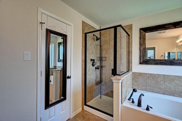 bathroom featuring tile patterned flooring, a textured ceiling, and independent shower and bath