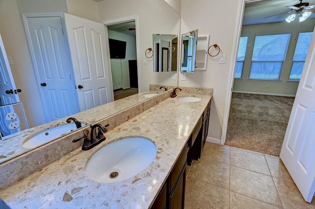 bathroom with tile patterned flooring, vanity, and ceiling fan