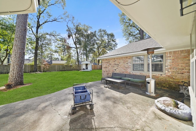 view of patio with an outdoor living space and a shed