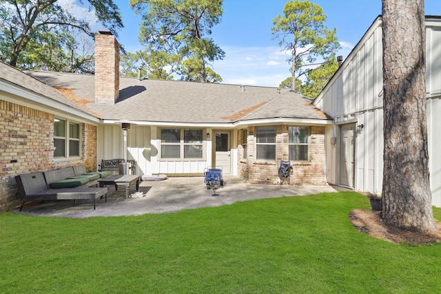 rear view of house with a lawn, a patio, and an outdoor hangout area