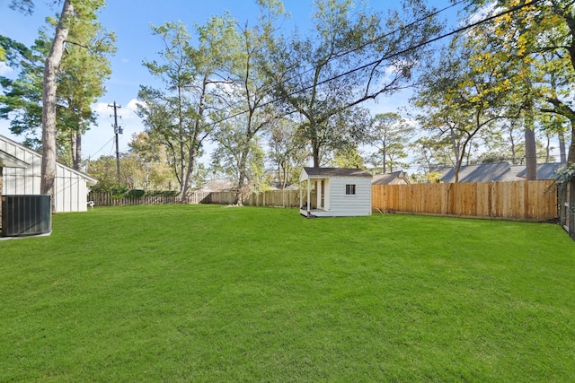 view of yard with a shed and central air condition unit