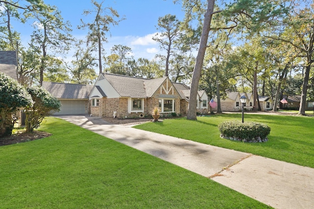 tudor house featuring a front lawn and a garage