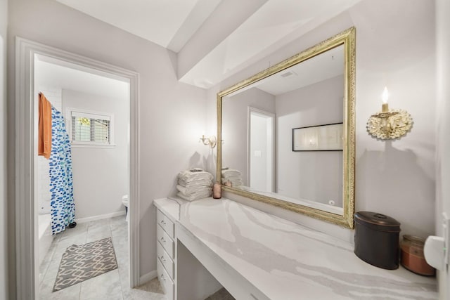 bathroom featuring tile patterned flooring, vanity, and toilet