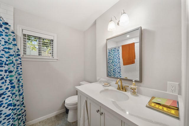 bathroom featuring tile patterned flooring, vanity, and toilet