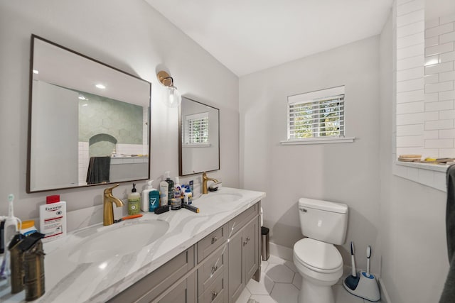 bathroom featuring tile patterned floors, vanity, and toilet