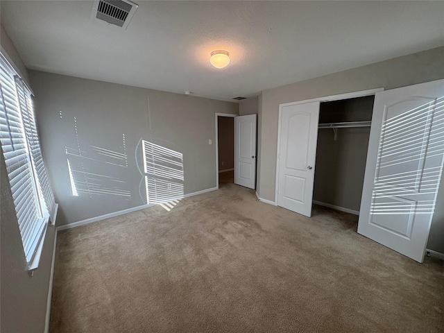 unfurnished bedroom featuring a closet and carpet floors