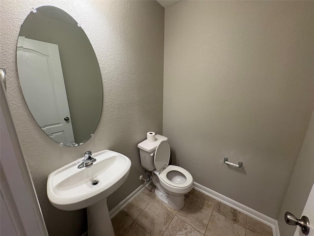 bathroom with sink, tile patterned flooring, and toilet