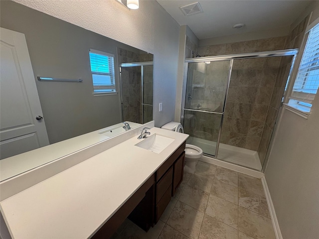 bathroom featuring vanity, toilet, and walk in shower