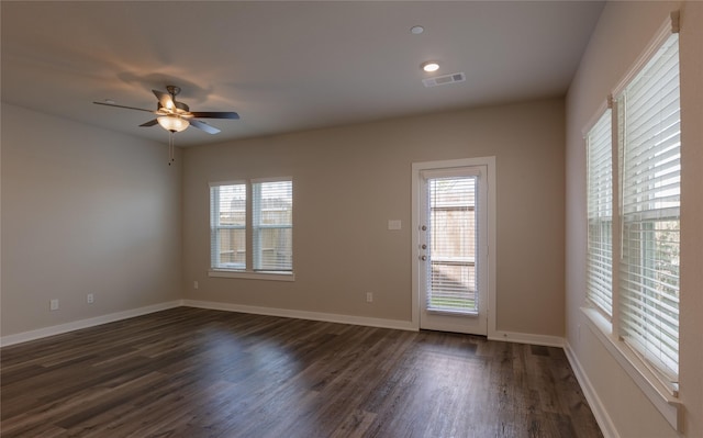 empty room featuring ceiling fan and dark hardwood / wood-style floors