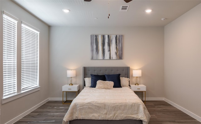 bedroom with ceiling fan, dark hardwood / wood-style floors, and multiple windows