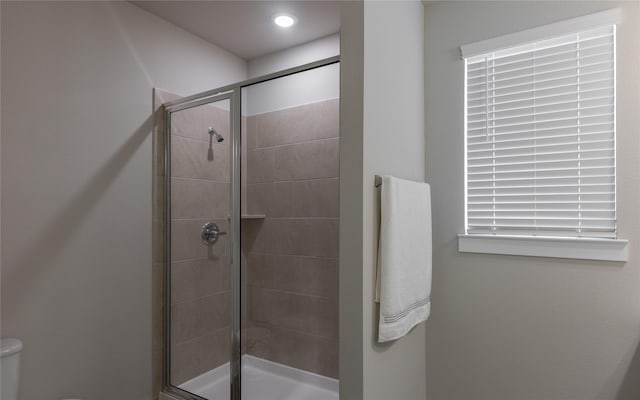 bathroom featuring toilet and walk in shower