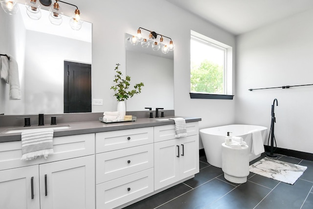 bathroom with tile patterned flooring, vanity, and a bathing tub