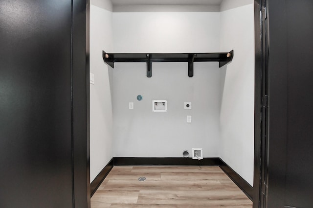 clothes washing area with electric dryer hookup, gas dryer hookup, light hardwood / wood-style flooring, and washer hookup