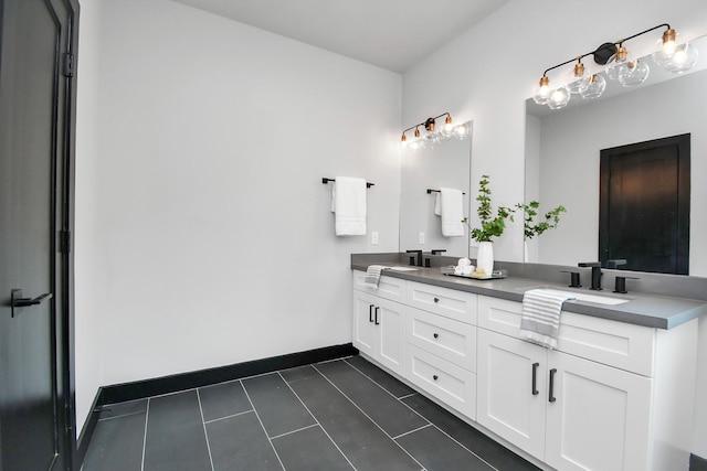 bathroom featuring tile patterned flooring and vanity