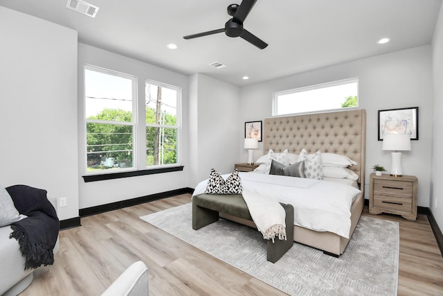 bedroom with multiple windows, ceiling fan, and light hardwood / wood-style flooring