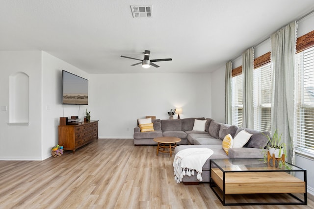 living room with ceiling fan, a healthy amount of sunlight, and light wood-type flooring