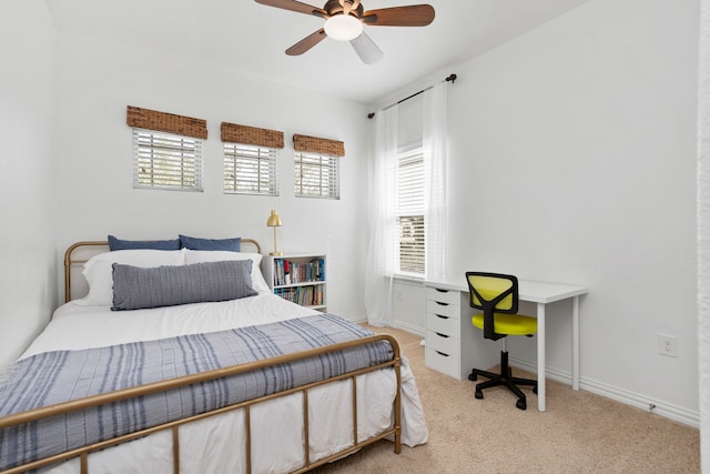 carpeted bedroom with multiple windows and ceiling fan