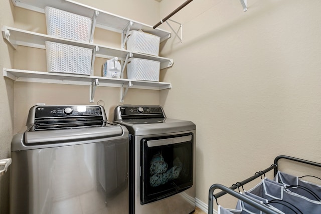 clothes washing area with independent washer and dryer