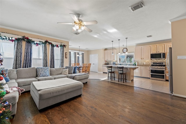 16507 Cypress Brook Ct, Cypress, TX 77429 - living room with healthy amount of natural light, ceiling fan, light wood-style flooring, and ornamental molding