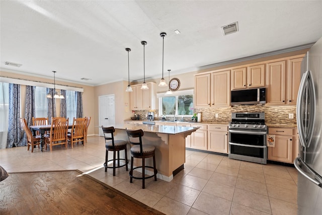 16507 Cypress Brook Ct, Cypress, TX 77429 - kitchen with stainless steel appliances, backsplash, crown molding, plenty of natural light, and a kitchen bar