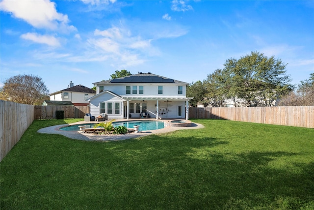 16507 Cypress Brook Ct, Cypress, TX 77429 - rear view of property featuring roof mounted solar panels, a pool with connected hot tub, and a patio area