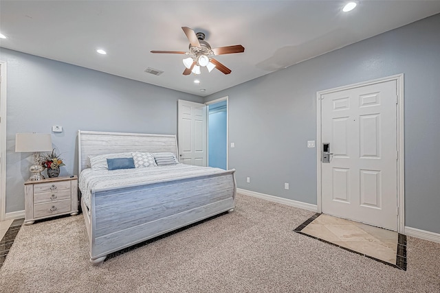 bedroom with ceiling fan and light carpet