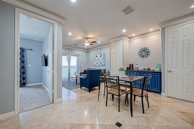 carpeted dining area featuring ceiling fan and ornamental molding