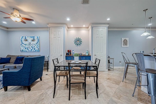 dining area with ceiling fan and ornamental molding