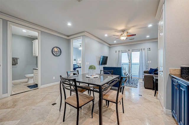 tiled dining area featuring ceiling fan and crown molding