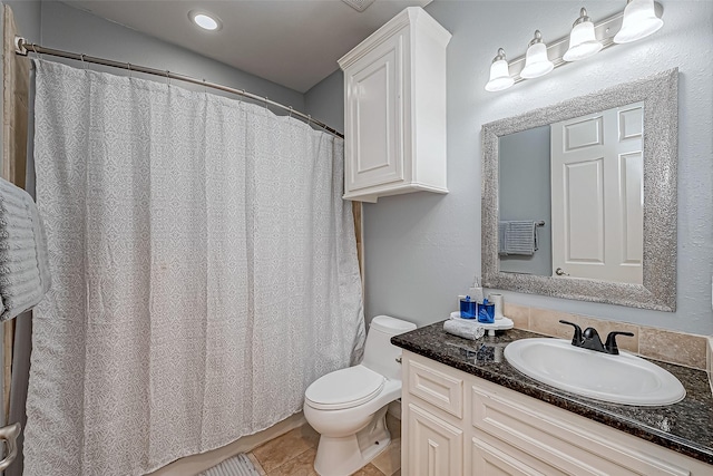 bathroom with tile patterned floors, vanity, and toilet