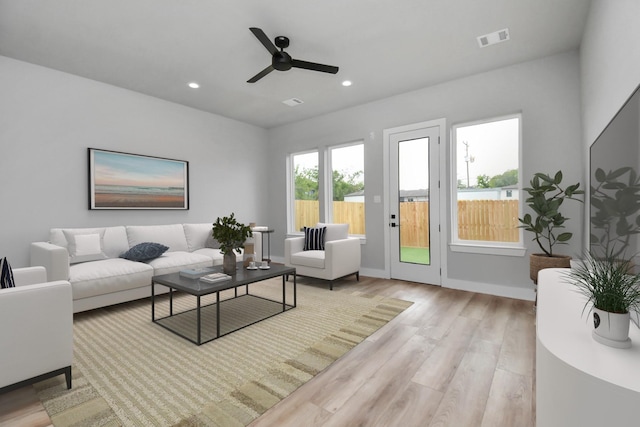 living room featuring ceiling fan and light hardwood / wood-style flooring