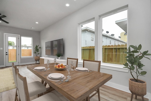 dining area with ceiling fan and light wood-type flooring