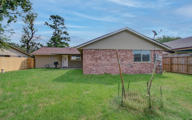 back of house with a lawn