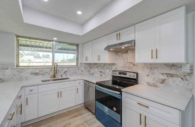 kitchen featuring stainless steel appliances, white cabinetry, and sink