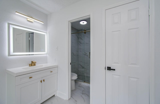 bathroom featuring vanity, toilet, and a shower with shower door