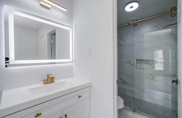 bathroom with vanity, toilet, and an enclosed shower