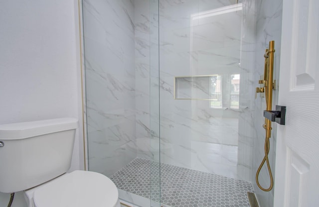 bathroom with tiled shower and toilet