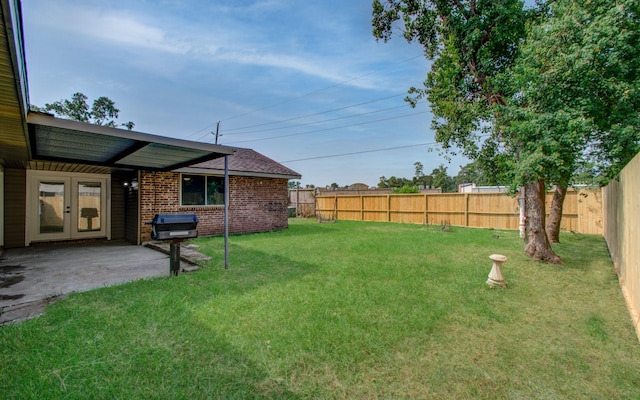 view of yard with french doors and a patio area