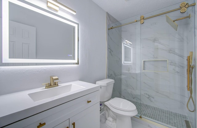 bathroom featuring toilet, vanity, a textured ceiling, and walk in shower