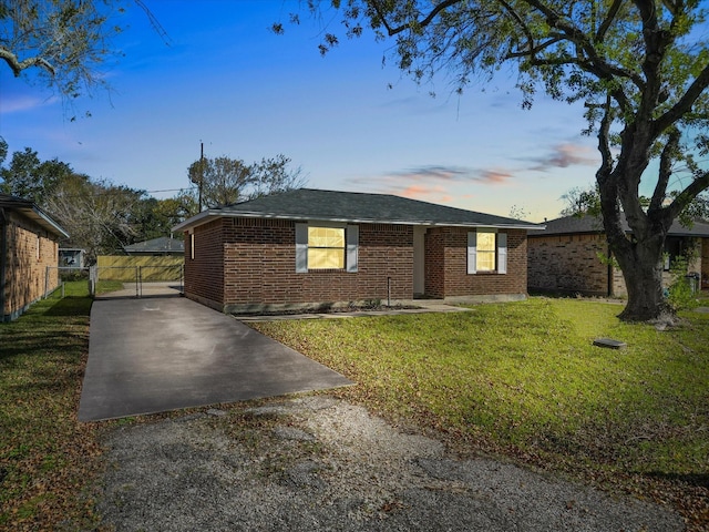 ranch-style home featuring a lawn