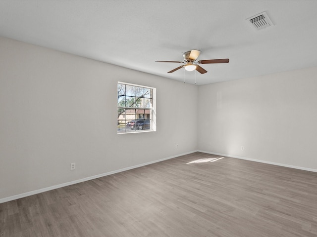 unfurnished room with ceiling fan and hardwood / wood-style floors