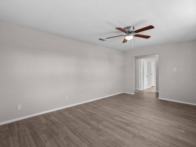 unfurnished room featuring dark hardwood / wood-style floors and ceiling fan