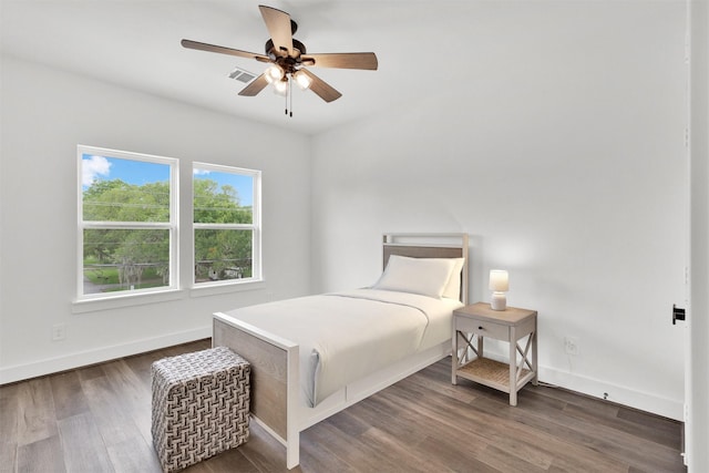 bedroom with ceiling fan and dark hardwood / wood-style floors