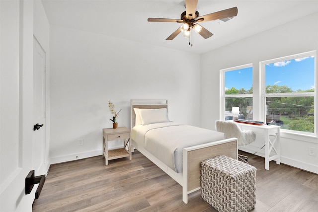 bedroom with hardwood / wood-style flooring and ceiling fan