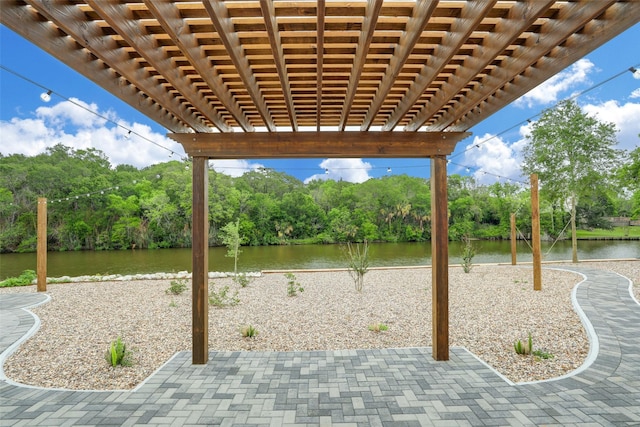 view of patio with a water view and a pergola